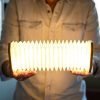 A portable rechargable lamp shaped like an accordion. With walnut wood octagonal ends and white tyvek pleated paper. pull the light to light up.