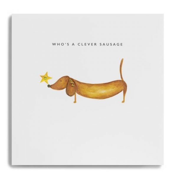 A white square card with a watercolour image of a little sausage dog with a star on it's nose in the centre of it. The wording Who's a Clever Sausage are printed above the image