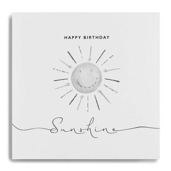 A white square card with an image of a sun with a smiling face which has been printed in grey and silver and is finished with little diamante jewels. The words Happy Birthday Sunshine are printed on the card too