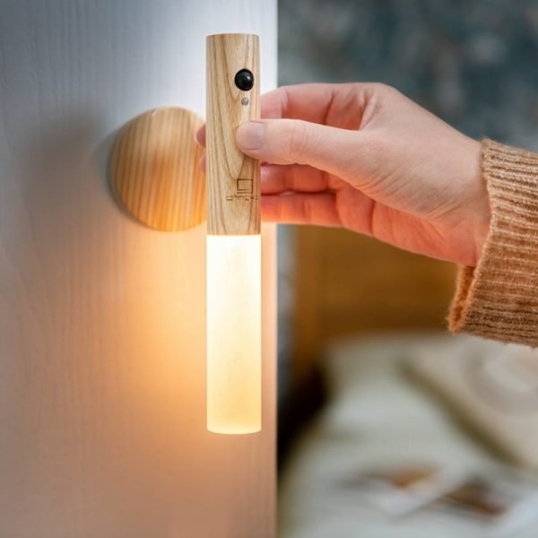 A smart frosted glass light on an adhesive wooden base that can be attached to any wall. The light detaches from the base to be used as a torch. Rechargeable and motion sensitive