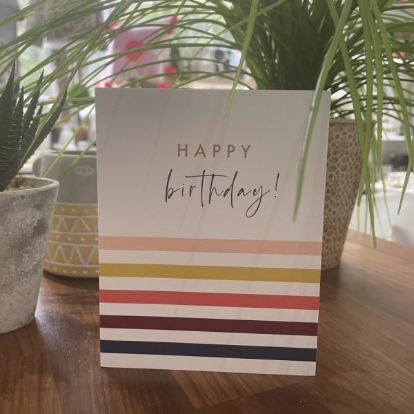 A birthday card with bold colourful stripes