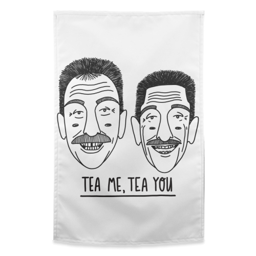 A white teatowel with an image of the Chuckle Brothers and the words Tea Me Tea You printed on it.