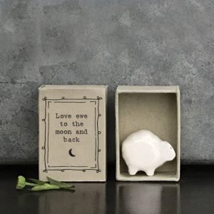 A cute little sheep ceramic keepsake in a matchbox with the words Love you to the moon and back printed on it