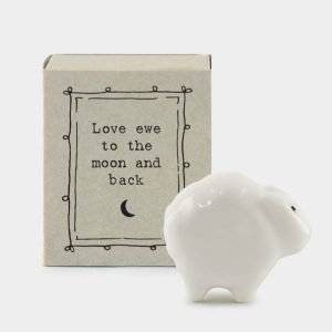 A cute little sheep ceramic keepsake in a matchbox with the words Love you to the moon and back printed on it