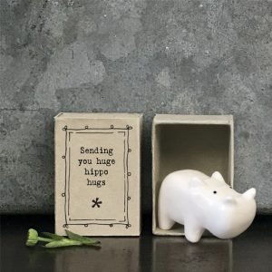 A sweet ceramic hippo keepsake in a matchbox with the words sending you huge hippo hugs printed on it.
