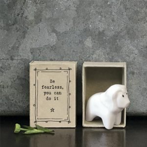 A sweet little lion ceramic keepsake in a matchbox with the words Be Fearless you can do it printed on it.