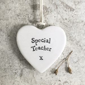 A small ceramic heart shaped keepsake with the words Special Teacher printed on it
