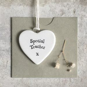 A small ceramic heart shaped keepsake with the words Special Teacher printed on it