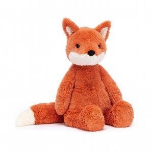 A sweet and very soft ginger fox with a long bushy tail and pointy ears.