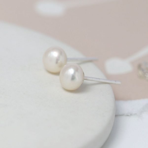 A pair of white freshwater pearl earrings with sterling silver posts and backs.