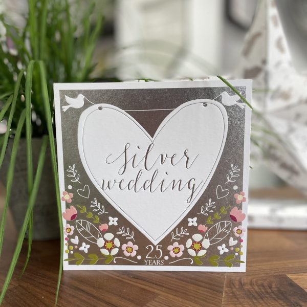 A lovely silver card with floral design and a large white heart with little white doves on it. The words SIlver Wedding are printed in the centre of the heart