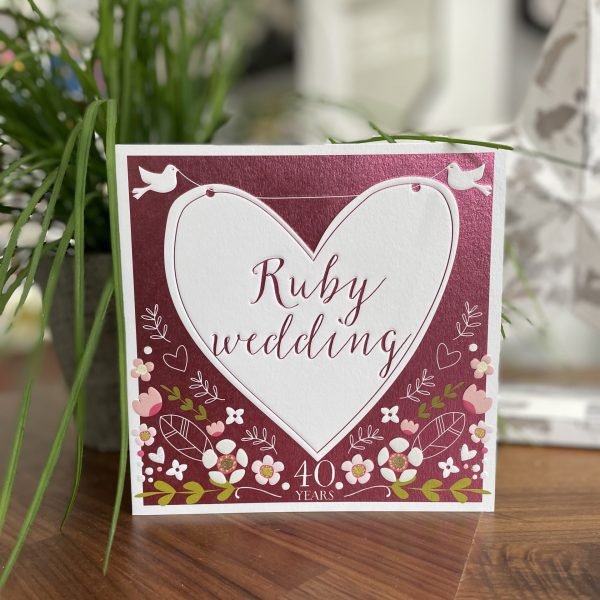 A lovely red card with floral design and a large white heart with little white doves on it. The words Ruby Wedding are printed in the centre of the heart