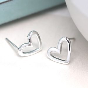 A pair of smooth asymmetric heart stud earrings made from sterling silver.