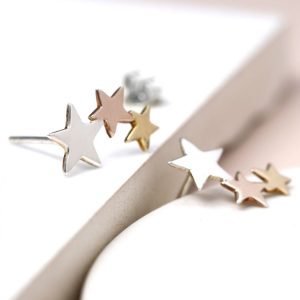 A pair of sterling silver triple star studs that have two of the stars plated in rose gold and yellow gold.