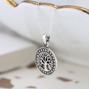 A lovely silver tree of life charm which has marcasite gemstones all the way around it.