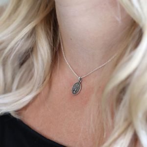 A lovely silver tree of life charm which has marcasite gemstones all the way around it.