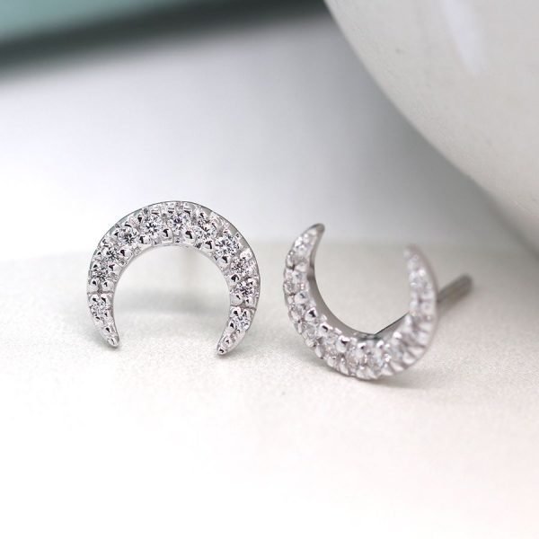 A pair of crescent moon stud earrings with cubic zirconia crystal effect.
