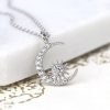 A beautiful moon and starburst charm necklace which is covered in cubic zirconia crystals on a 16 inch silver chain.