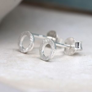 A pair of brushed silver circle stud earrings
