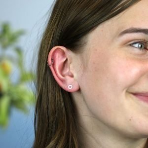 A pair of brushed silver circle stud earrings