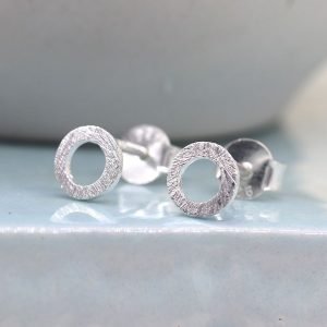 A pair of brushed silver circle stud earrings