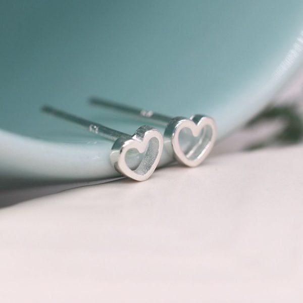 A pair of sweet tiny cutout heart stud earrings made from sterling silver