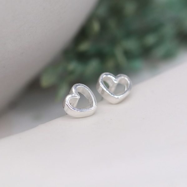 A pair of sweet tiny cutout heart stud earrings made from sterling silver