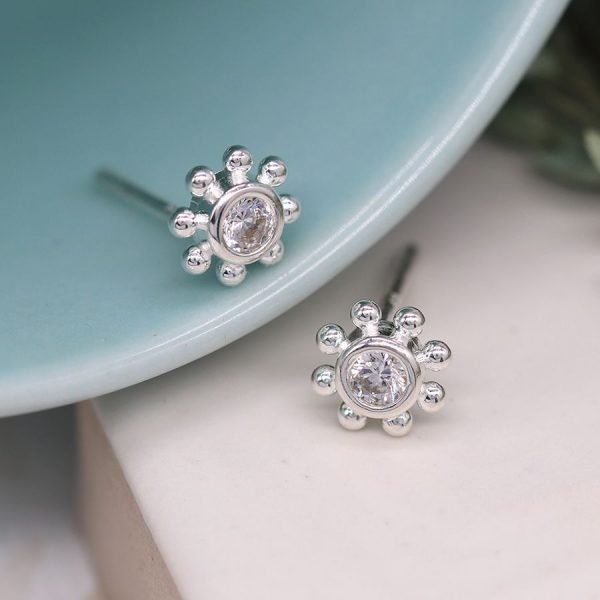 A lovely pair of flower style stud earrings with a faceted cubic zirconia centre and fancy edging made from sterling silver.