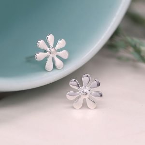 A sweet pair of sterling silver daisy stud earrings with a seven petal design