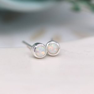A lovely pair of sterling silver round stud earrings with an iridescent opal setting.