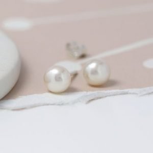 A pair of white freshwater pearl earrings with sterling silver posts and backs.
