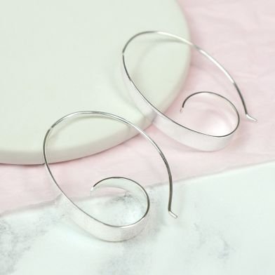 A pair of silver spiral hoop earrings.