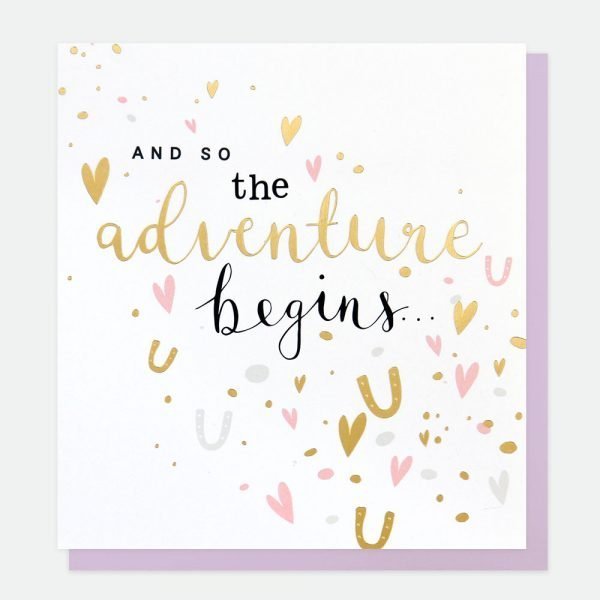 A wedding card with gold foil horeshoes and hearts and the words and so the adventure begins