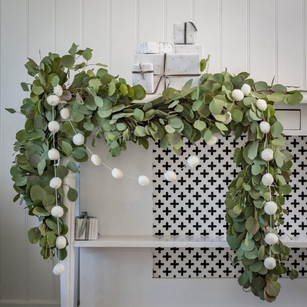 A 2.5 metre making a white pompom garland.