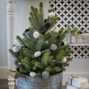A string of grey and white pom poms which look amazing adorning a christmas tree or strung across a mantlepiece.