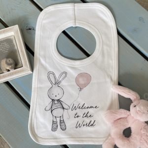A sweet white bib with a cute bunny holding a pink balloon design