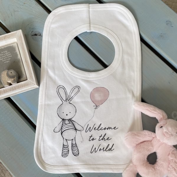 A sweet white bib with a cute bunny holding a pink balloon design