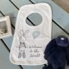 A sweet little bib with an image of a cute bunny holding a blue balloon and with the words Welcome to the World printed on it