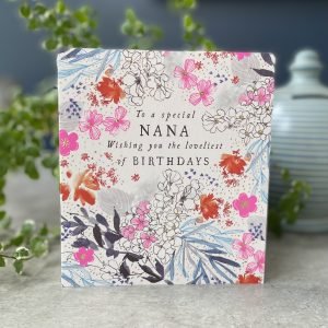 A beautiful card with flowers all over it and the words 'To a Special Nana. Wishing you the loveliest of birthday' printed on it.