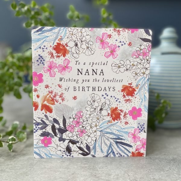 A beautiful card with flowers all over it and the words 'To a Special Nana. Wishing you the loveliest of birthday' printed on it.