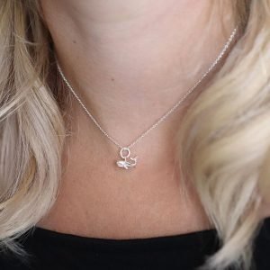A sterling silver necklace with a little silver whale pendant on a fine silver chain