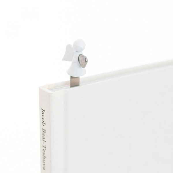A metal bookmark with a little white angel carrying a silver heart on the top