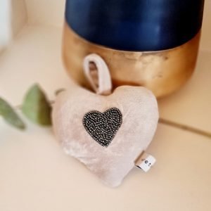 A cream velvet padded hanging heart with a hand embroidered beaded heart