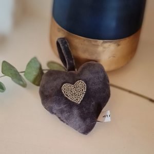 A grey velvet padded hanging heart with a hand embroidered beaded heart