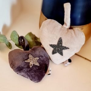 A velvet padded heart in either cream or grey with an embroidered beaded star
