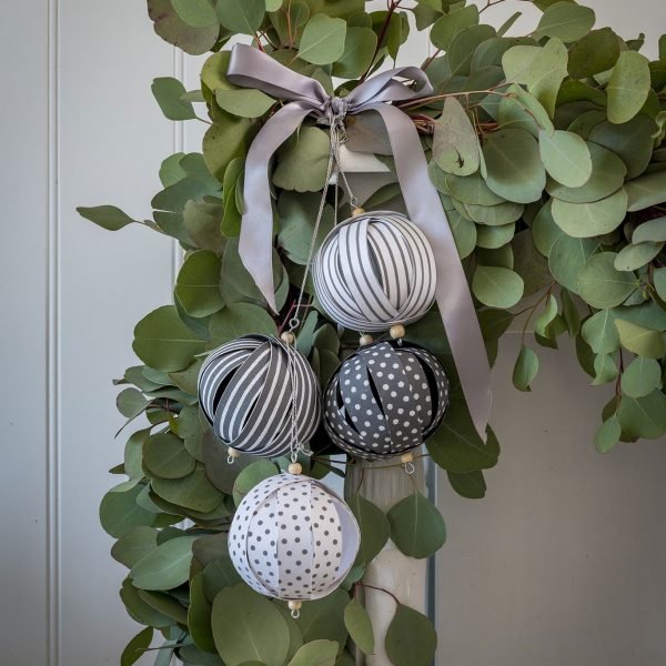 A set of 4 paper christmas baubles in tones of grey and white