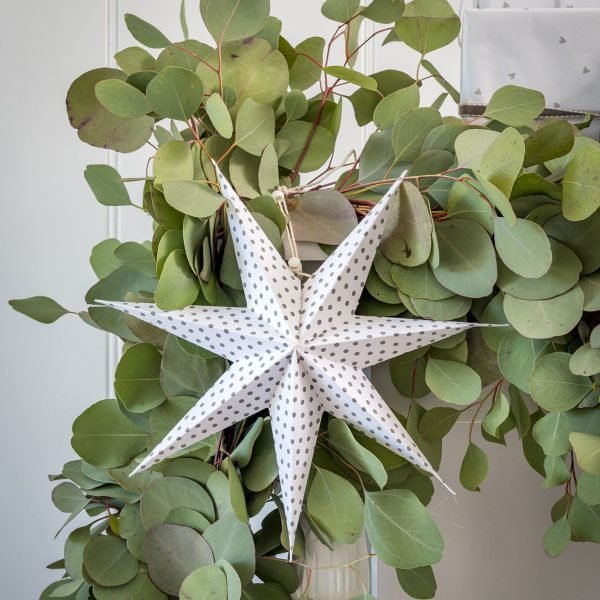 A fold out paper star in white with grey polka dots