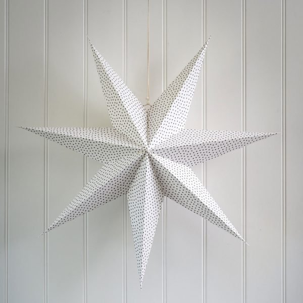 A fold out paper star in white with grey polka dots