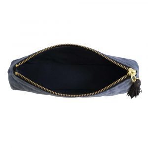 A blue velvet quilted pouch for keeping either pens and pencils or cosmetic brushes in.