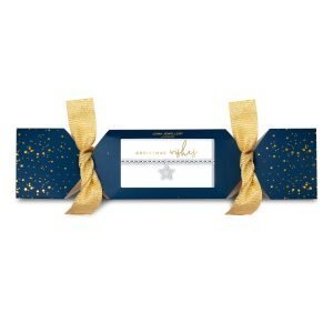 A lovely silver plated stretch bracelet with a sparkly star charm which is packaged in cracker packaging that is dark blue with gold and silver spots and gold ribbons on each end.